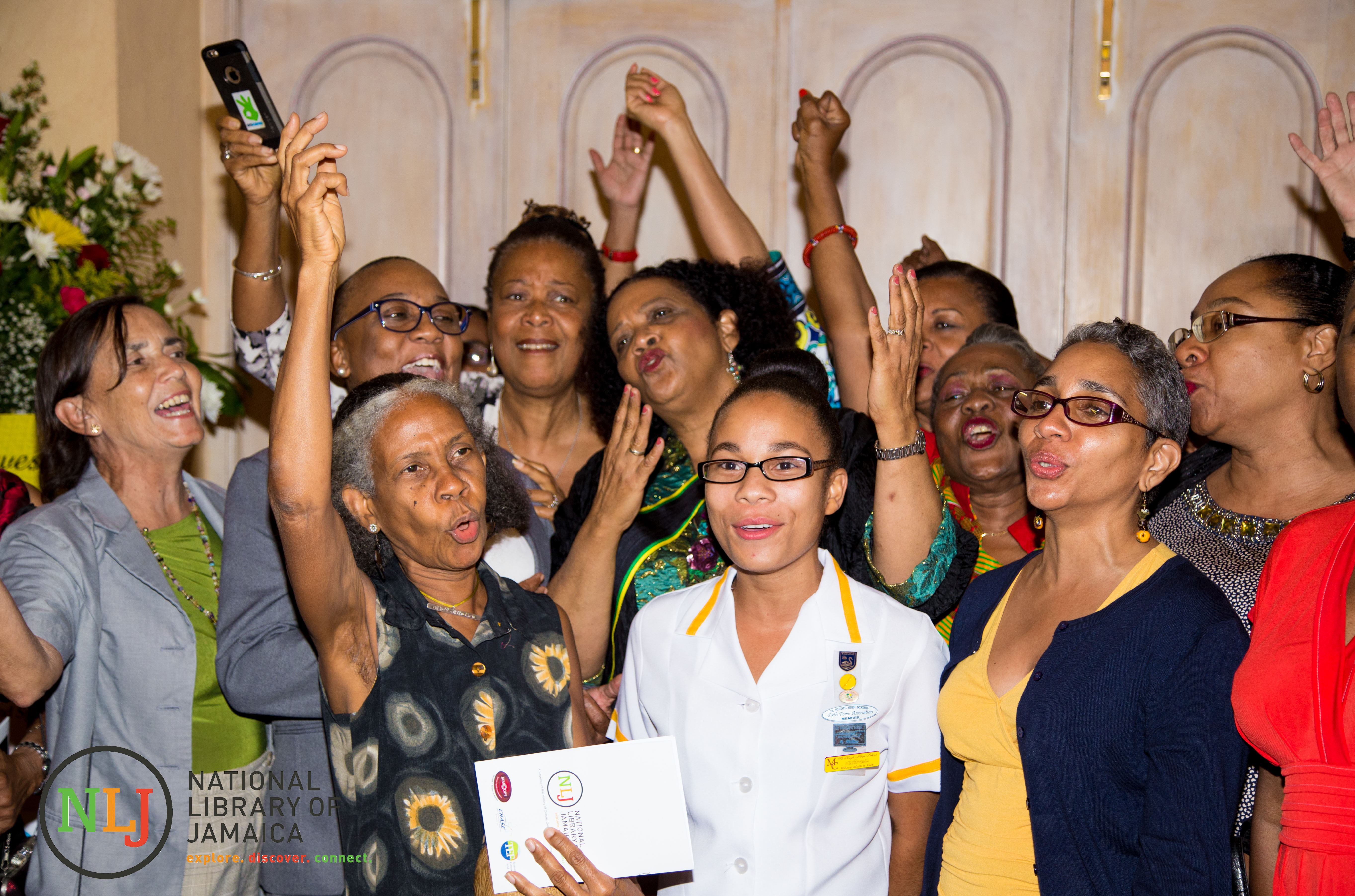 Past Students of St. Hugh's High School sing their school song at the Ceremony of Investiture of the Poet Laureate of Jamaica